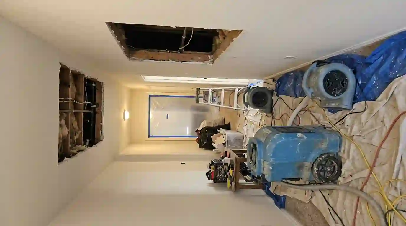Opened apartment ceiling drying below a leak from the unit above