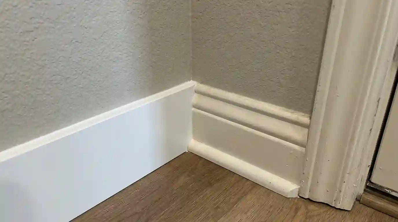 New baseboard coped into existing trim after water damage
